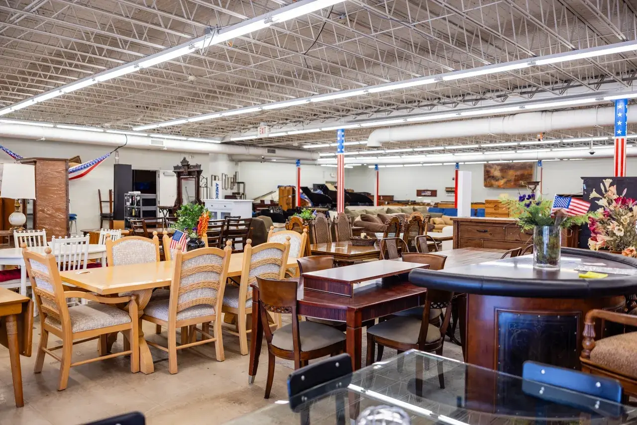 Furniture store interior with various wooden tables.