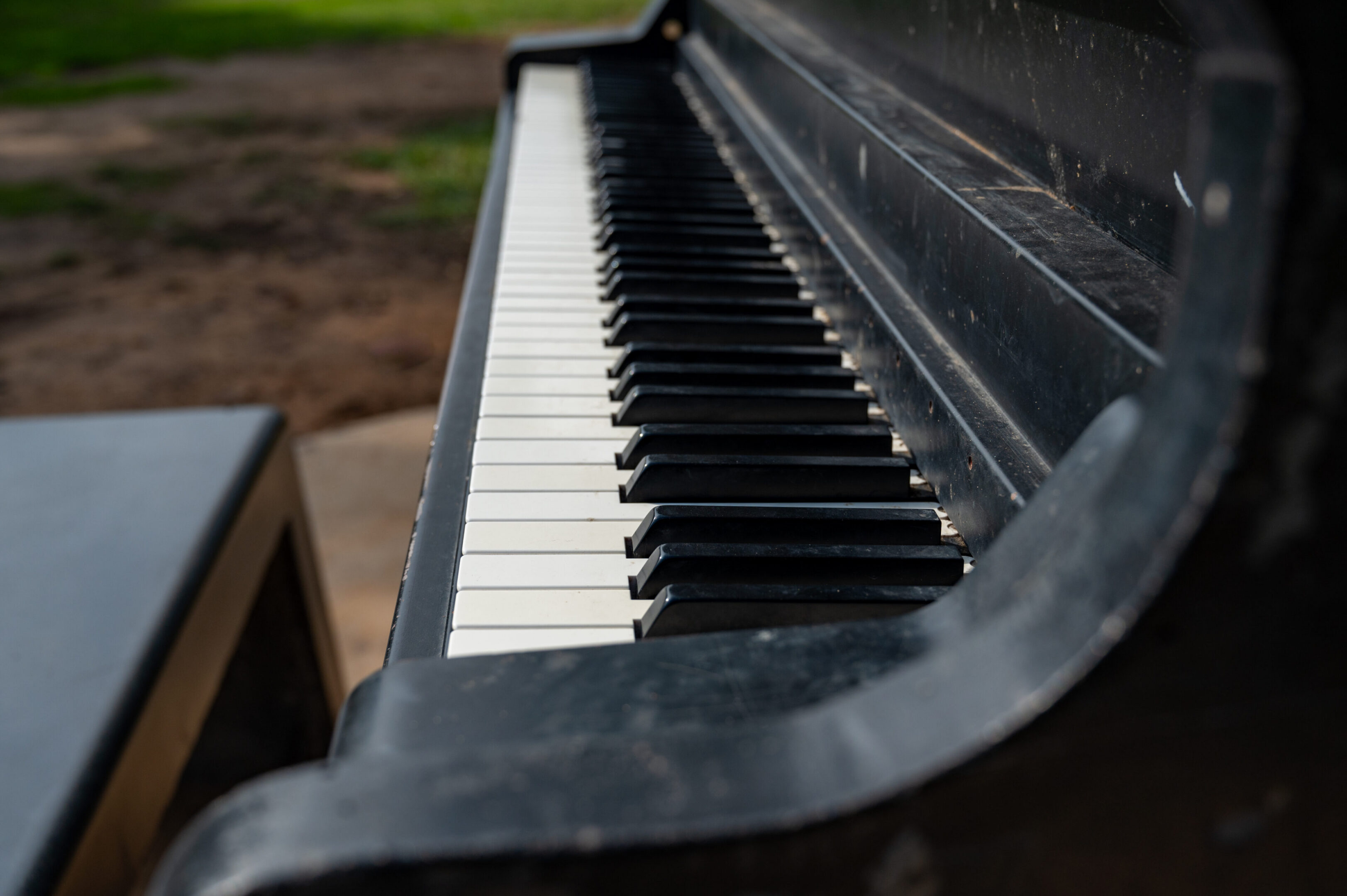 Piano black piano in the park during the day close up